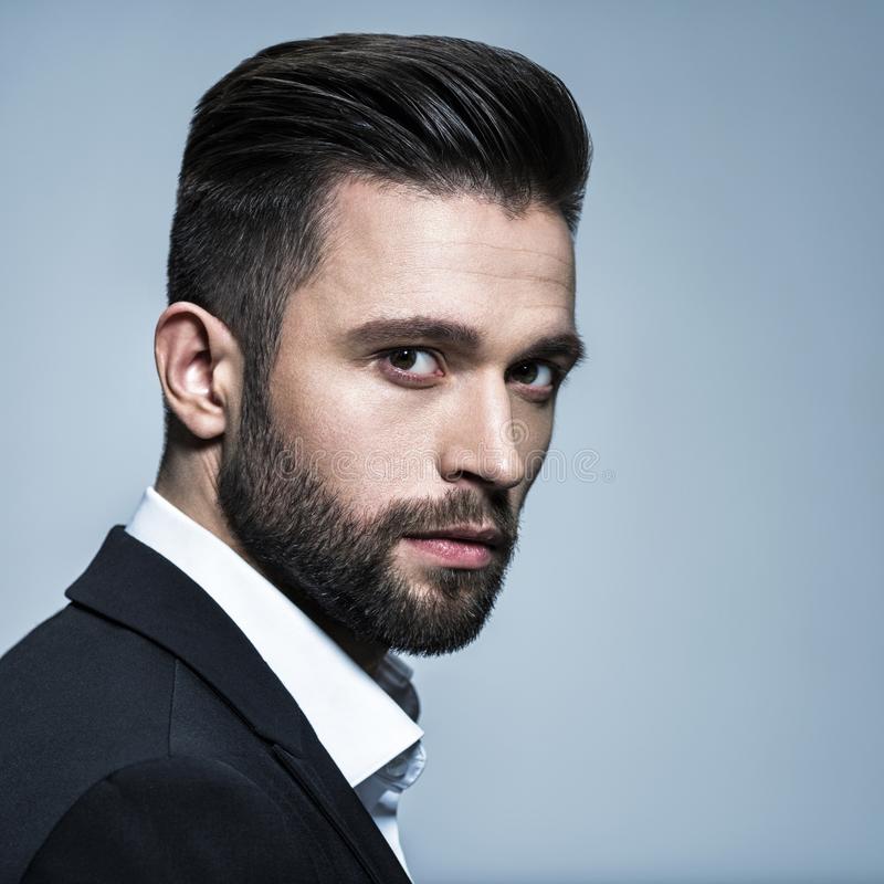 handsome-man-black-suit-white-shirt-posing-studio-attractive-guy-fashion-hairstyle-confident-man-short-beard-125019349